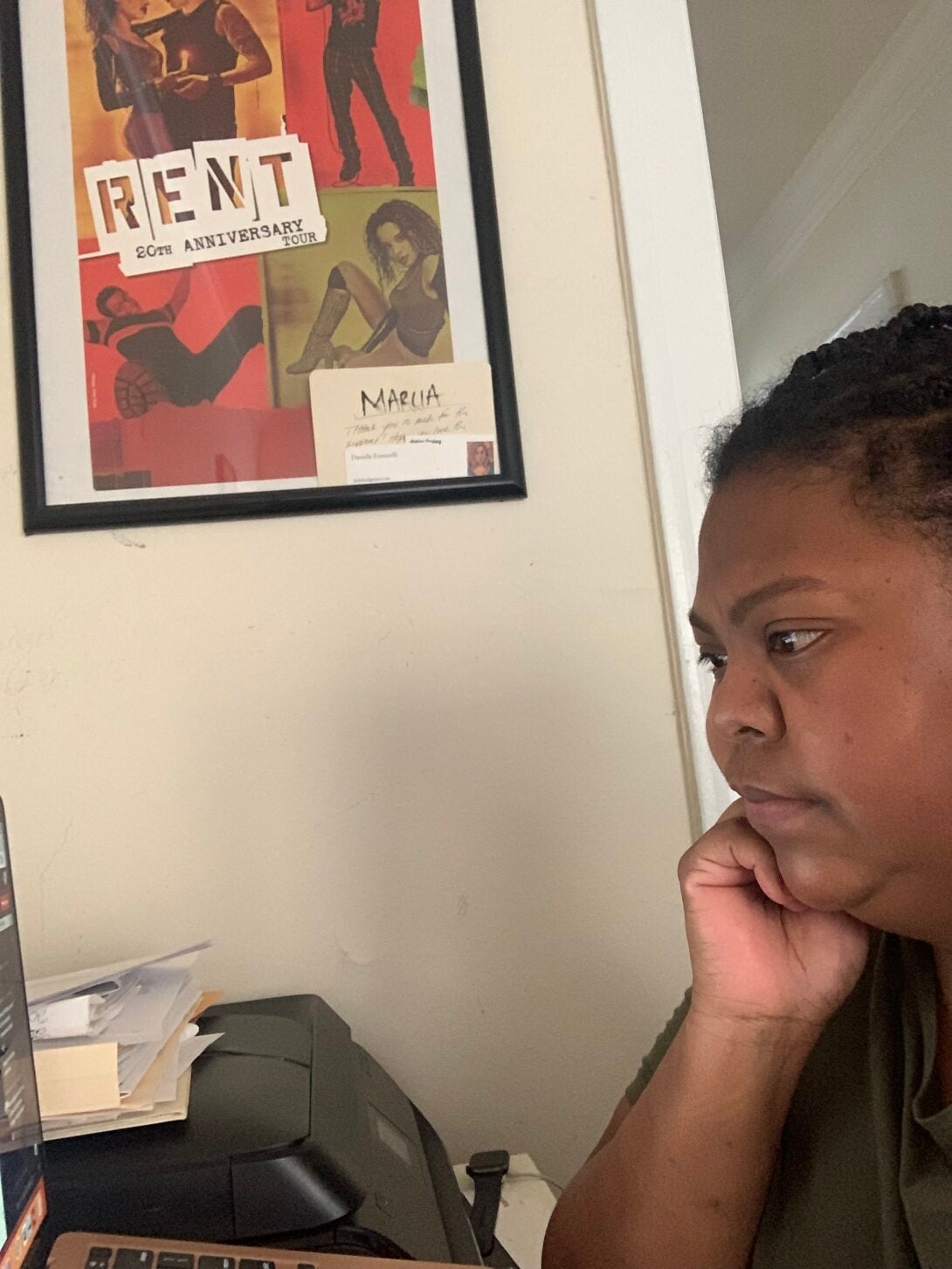 A student pensively looking at her laptop.