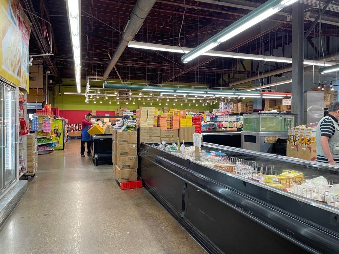 An aisle of refrigerated products inside a grocery store